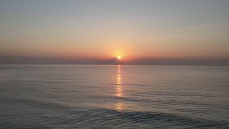 Aerial-Drone-Shot-of-a-Beautiful-Calm-Sunrise-Over-the-Gulf-of-Thailand-with-Reflection