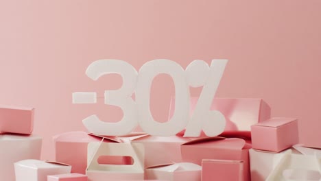 Minus-thirty-per-cent-text-in-white-with-pink-and-white-gift-boxes-on-pink-background