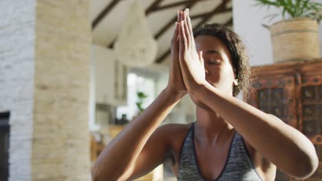 video of relaxed african american woman practicing yoga at home