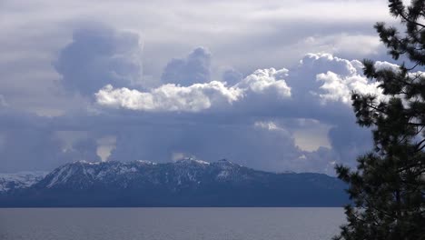 beautiful time lapse of thunderstorm cloud formations rising behind snow covered mt tallac and the desolation wilderness near lake tahoe california 1