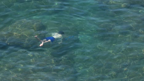 a boy snorkeling in the ocean near sorrento