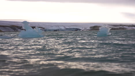 Floating-Ice-in-Cold-Sea-Water-Under-Glacier,-Cinematic-Slow-Motion