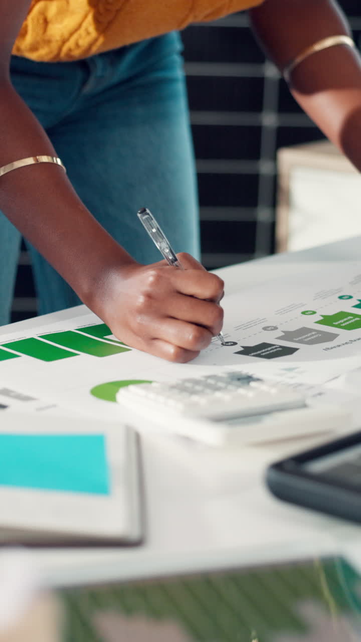 Close-up of Hands Analyzing Business Documents and Using Calculator