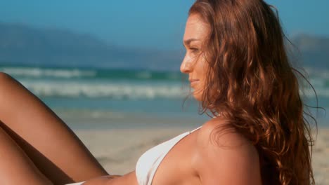 beautiful young caucasian woman in bikini relaxing on beach in the sunshine 4k
