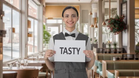 happy indian woman waiter holding tasty banner