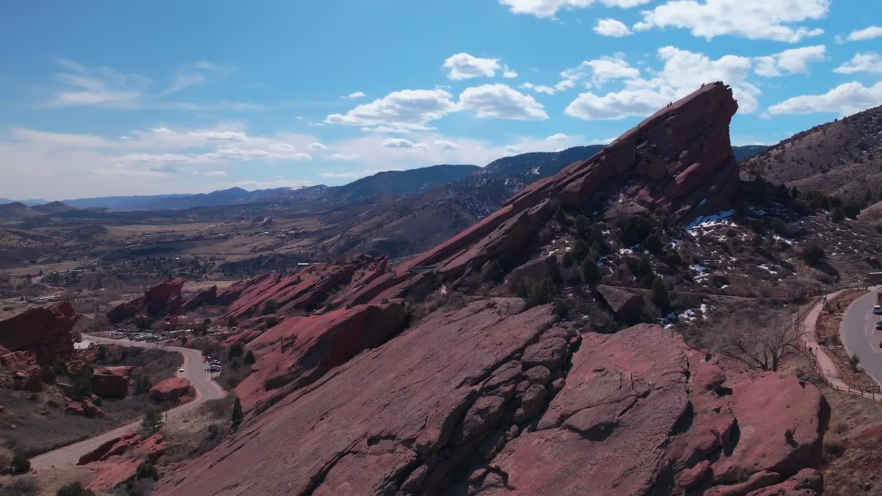 Red Rocks Park and Amphitheater Mount Morrison Colorado aerial drone mid winter windy roads walking trails Trading Post sunny blue sky clouds full parking lot cars stairs tourist area circle left