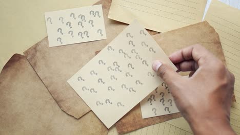 high angle view of question mark on paper on office desk