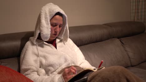 woman dressed in rabbit pajamas doing calculations