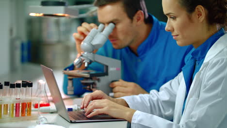 chemical scientist team research. female scientist typing on laptop