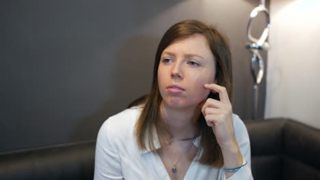 Pensive-young-woman-thinking-at-home-sitting-in-a-kitchen