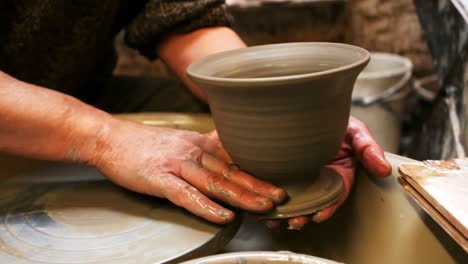 mid section of potter making pot