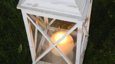 white wooden vintage lantern with burning candle