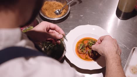 Close-up-shot-of-a-delicious-Italian-dish-prepared-by-the-cook-on-a-round-white-plate