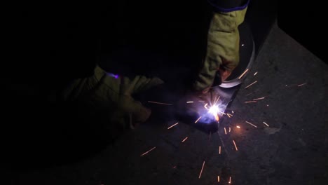 precision stick welding a corner edge of a l frame in the dark