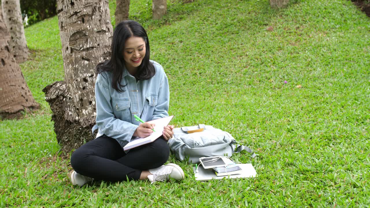 Woman Studying Outdoors in a Park