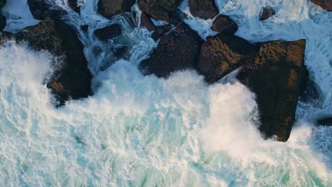 beautiful stormy sea foam splashing at seashore cliffs. aerial foamy ocean waves