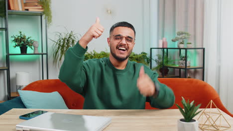 excited happy indian man surprised shocked by sudden victory good win news celebrate wow reaction