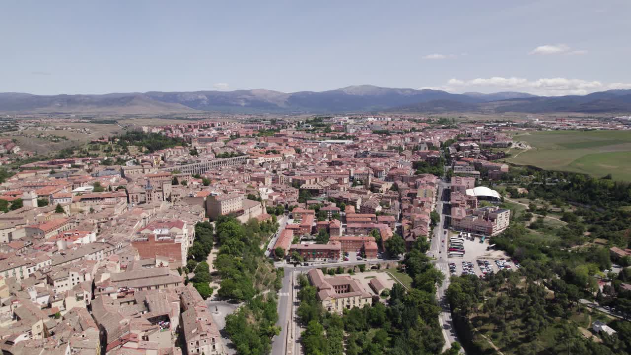 Aerial: Segovia cityscape with aqueduct in background, Spain's heritage showcased