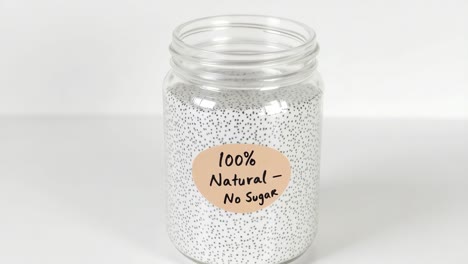 organic chia seeds filling glass container, displaying natural label highlighting nutritional benefits and clean eating concept