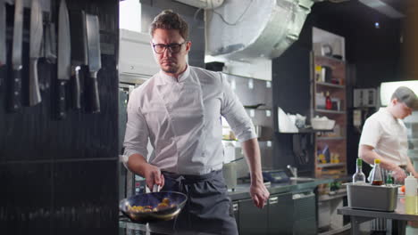 chef flambeing food in restaurant kitchen