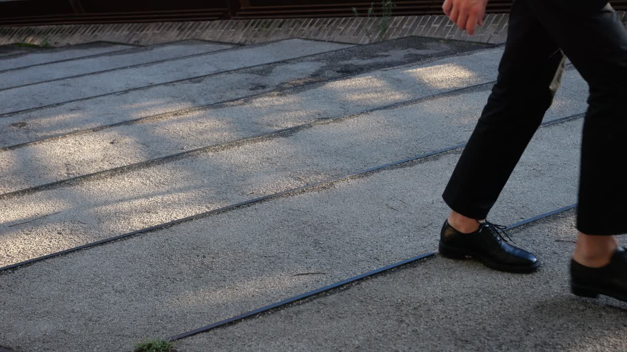 A person walking up stairs wearing dress shoes