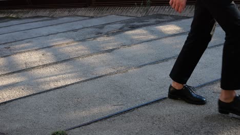 a person walking up stairs wearing dress shoes
