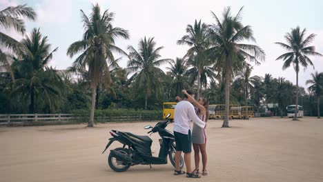 man gets off motorbike approaches girl kisses and hugs