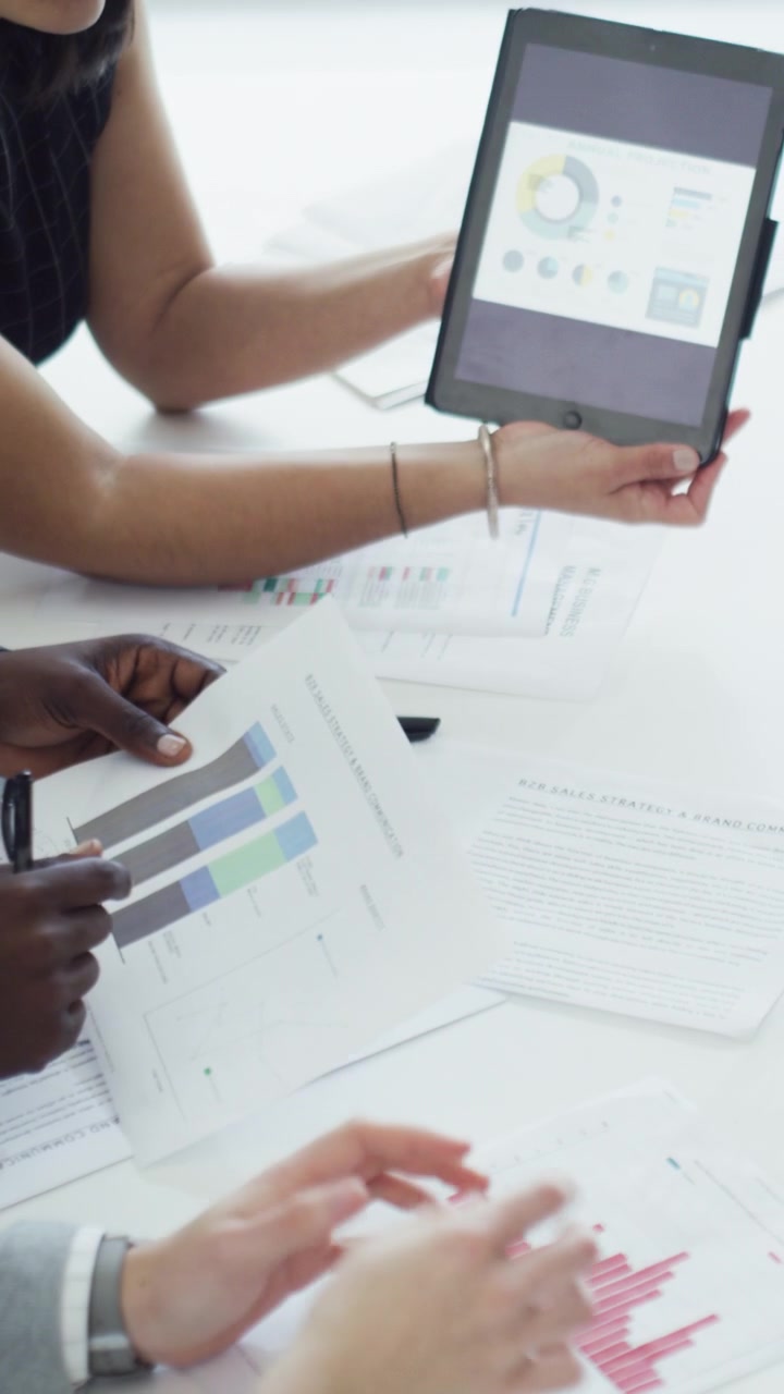 Business Team Reviewing Financial Charts and Data in Office Meeting