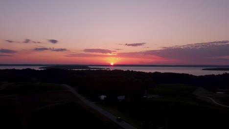 sun setting over a grape vineyard in northern michigan, united states