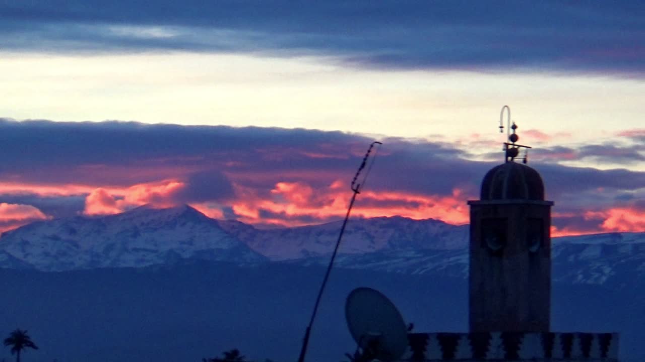 early morning pink skies, mountains and mosque marrakesh morocco