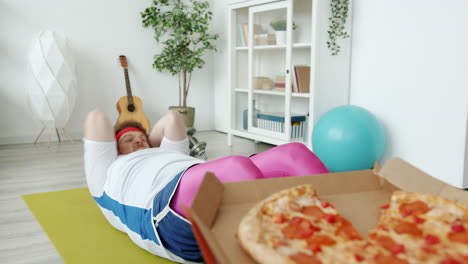funny guy trying to workout with pizza
