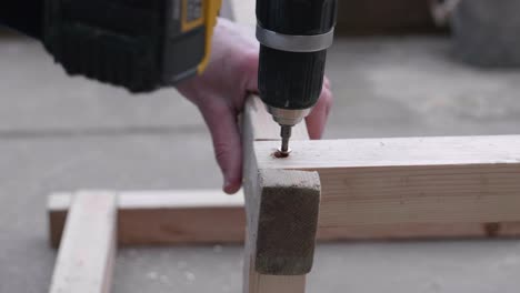 screwing together a timber frame.