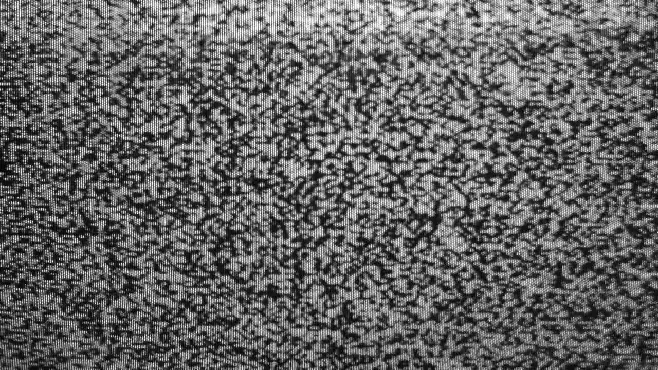 Abstract noise of analog television. Digital glitch. Damage to the video signal with pixel noise and noise. Video error. Black and white dreaming background. Retro tv.