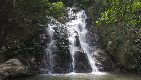 waterfall ends in large tropical pool deep in forest jungle of minca colombia