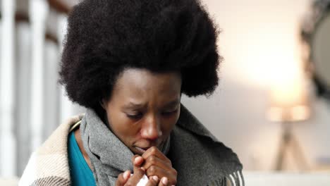 close up portrait of african american female wearing a scarf, sitting at home