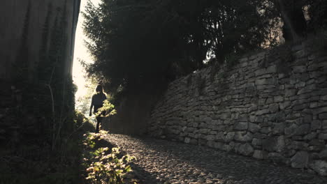 a girl walking in a small road in a french village