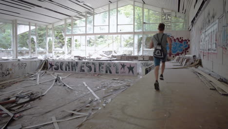 man running in an abandoned swimming pool in realtime