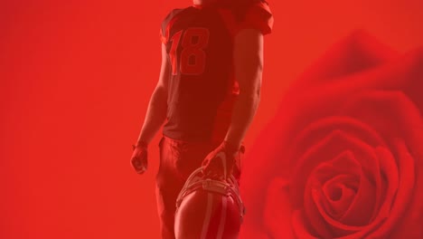 Animation-of-midsection-of-american-football-player-holding-ball-over-red-rose-background