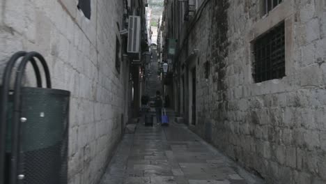 two travellers walk down an ally in old town, dubrovnik