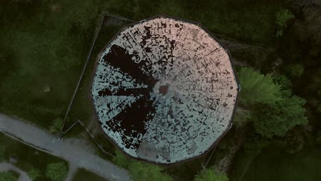 aerial – fast rotating camera movement above a water tank tower during sunset