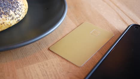 credit card and smartphone on a table with food