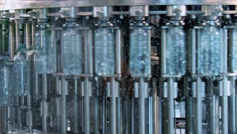 new plastic bottles on the conveyor belt of a drinking water plant