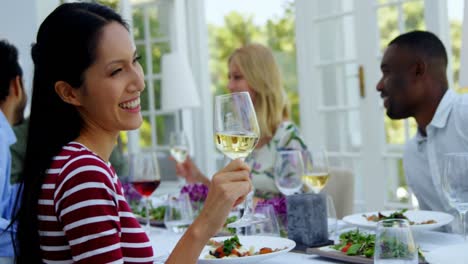 Two-friends-toasting-glasses-of-wine-in-restaurant