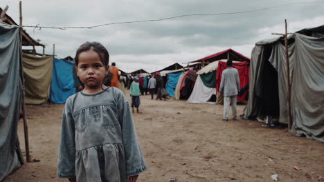 portrait of a young girl in a displaced camp