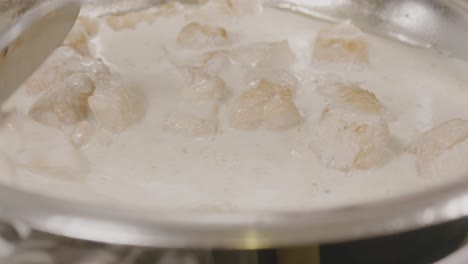 cooking with coconut milk in a pan