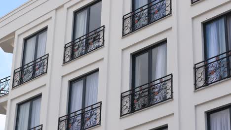 modern apartment building facade with ornamental balconies