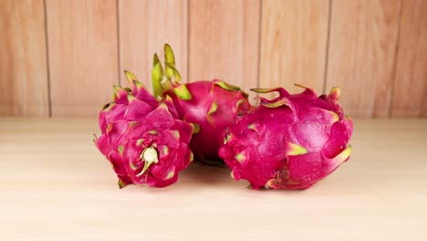 Dragon fruits arranged on a wooden table