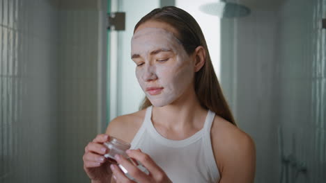 closeup woman moisturizing mask in morning. pretty girl doing skincare treatment
