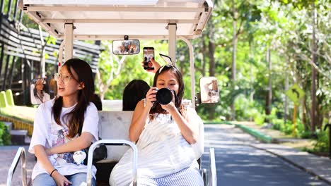 girls taking pictures in a golf cart