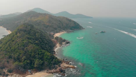 green hilly island surrounded by boundless azure ocean